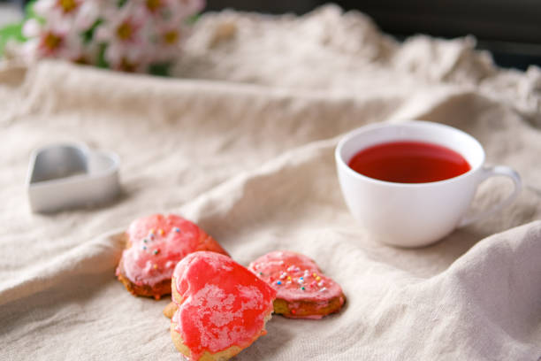 istock Heart shaped red hand made cookies and hibiscus tea. 1301844374