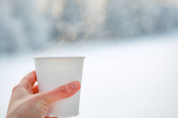 istock Woman's hand holding white paper cup 1301844377