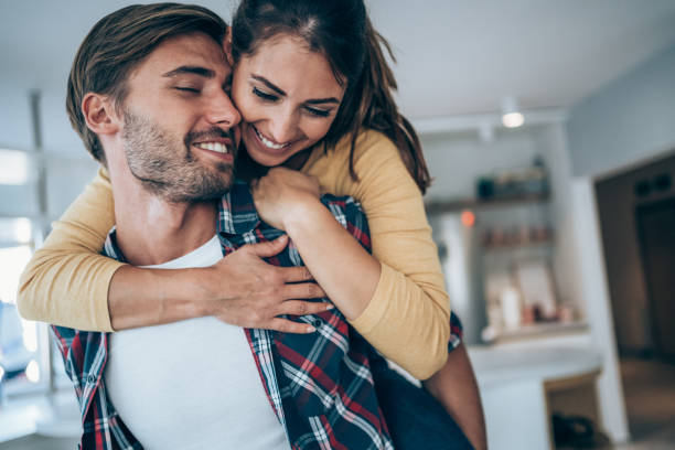 istock Young happy couple piggybacking at home. 1301844631