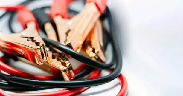 Photo of Close up of red and black car battery jumper cable