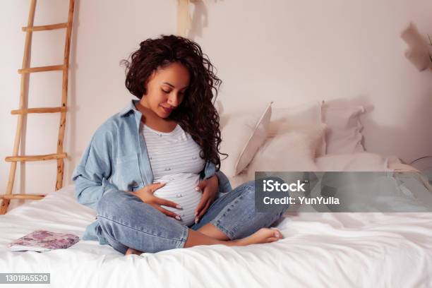 Young Pretty African American Woman Pregnant Laying In Bed Lifestyle People Concept Stock Photo - Download Image Now