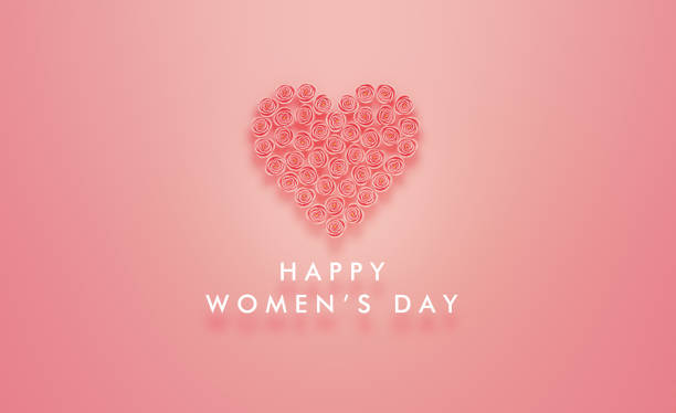 Happy Women's Day message written below a heart which is made of pink roses on pink background. Horizontal composition with copy space. Women's Day concept.
