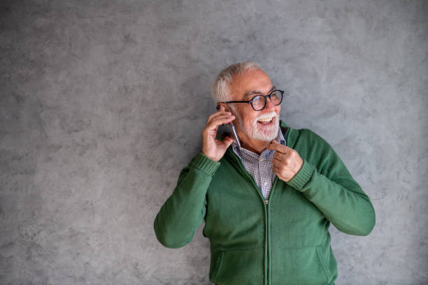 istock Old adult smiling, talking on phone. Copy-space. 1301847507