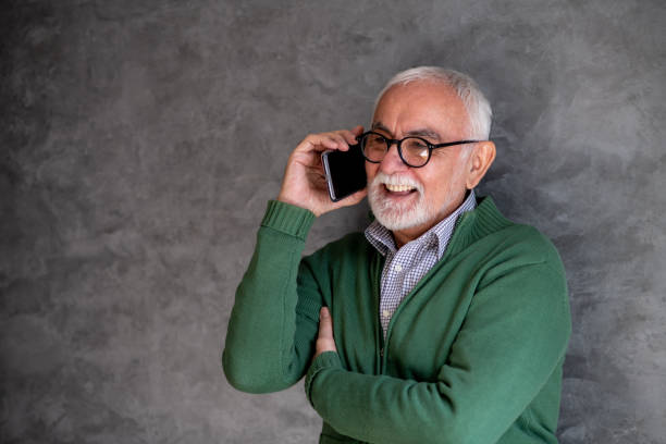 istock Senior man talking on phone, smiling. Copy- space. 1301848312