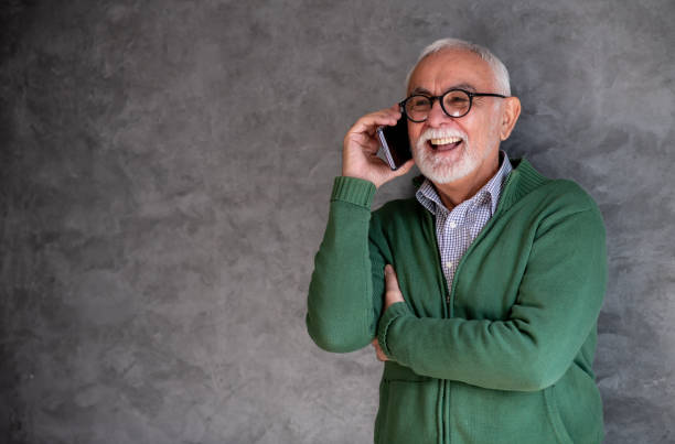 istock Senior man enjoying in conversation on mobile. Copy- space. 1301848470