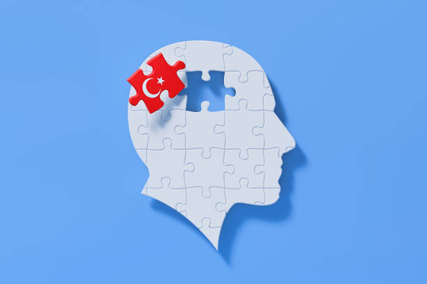 istock Turkish Learning Concept - White Jigsaw Puzzle Pieces Forming A Human Head Shape On Blue Background 1301849243