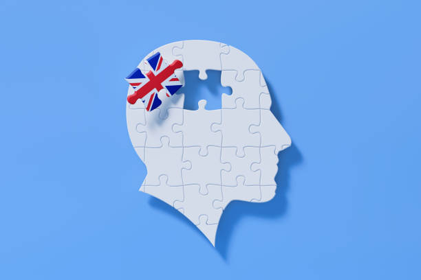 istock English Learning Concept - White Jigsaw Puzzle Pieces Forming A Human Head Shape On Blue Background 1301849808