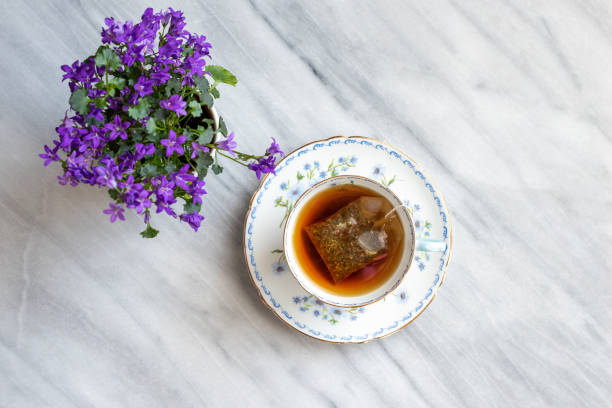 hübsche vintage floral teetasse mit heißen tee - old fashioned tea cup victorian style beauty stock-fotos und bilder