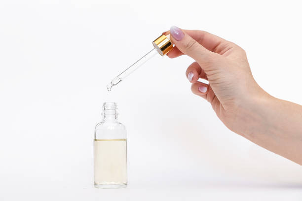 istock Dropper glass Bottle Mock-Up. Oily drop falls from cosmetic pipette on white background 1301856215