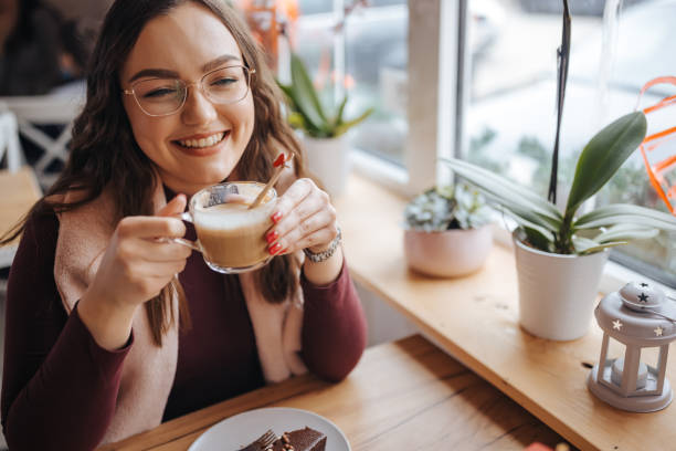 istock Smiling young woman enjoying dessert in restaurant 1301857046