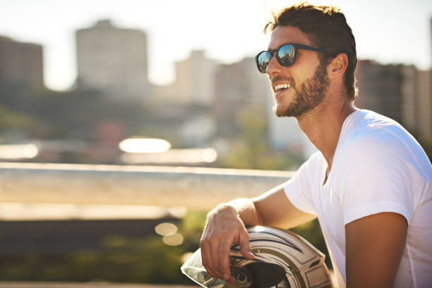 Shot of a young man riding a motorbike through the city
