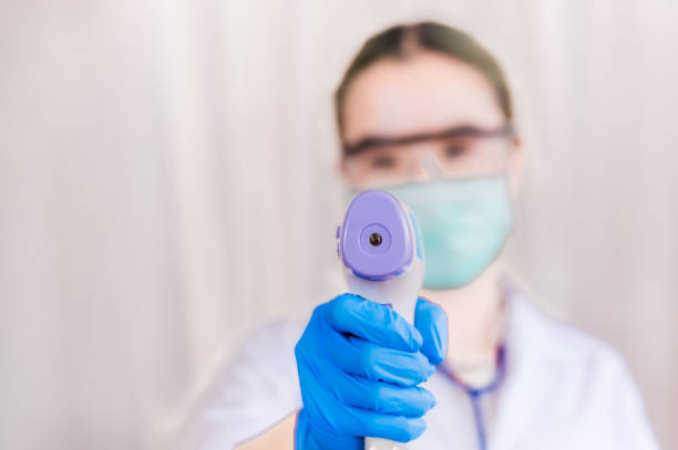 istock Closeup of infrared forehead thermometer gun 1301870406