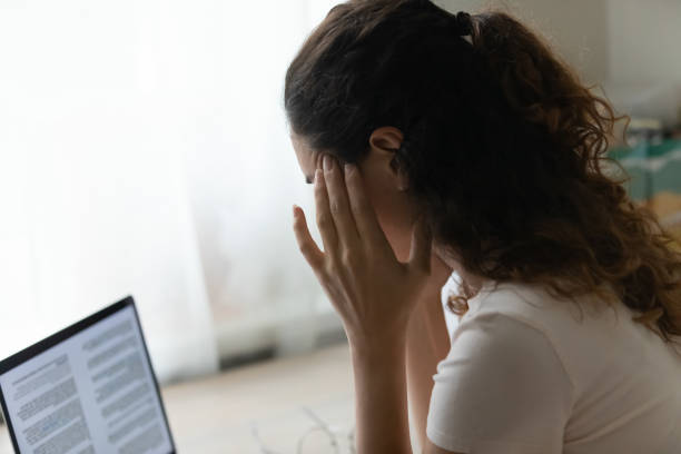 istock Tired young female overworked by computer suffer of headache migraine 1301871010