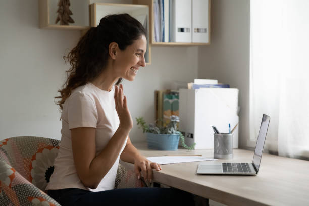 istock Happy millennial female making video call by laptop using webcam 1301871011