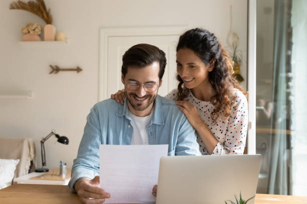 istock Glad married couple impressed with perfect news received by mail 1301871026