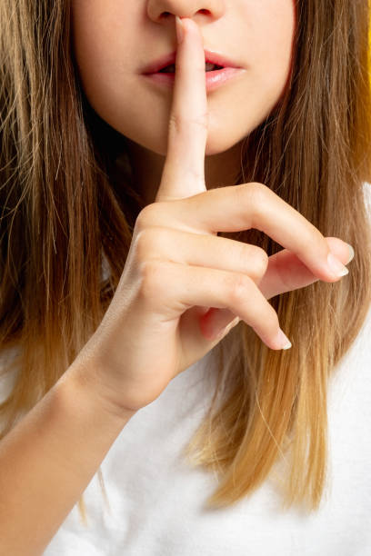 istock child secret hush gesture keep quiet girl shhh 1301871112