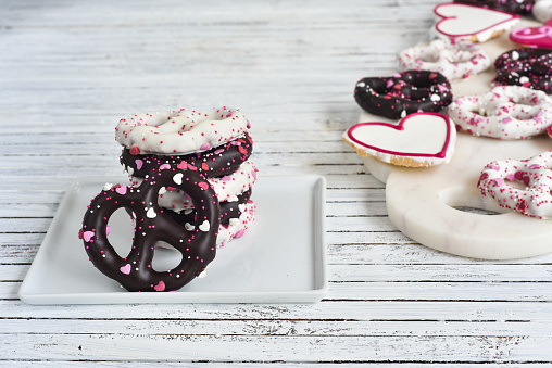 Valentine's Day treats made of decorative cookies and chocolate covered pretzels