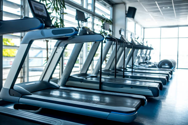 istock Side View of Treadmills at Modern Gym 1301879242