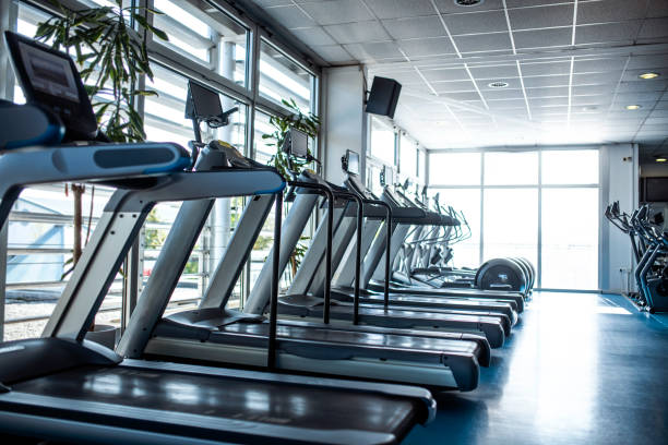 istock Side View of Treadmills at Modern Gym 1301879244