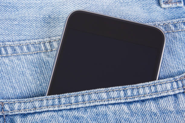 istock Mobile phone with blank screen in pocket jeans, smartphone 1301884915
