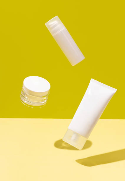 istock Creative layout with levitating beauty products on yellow background 1301887284