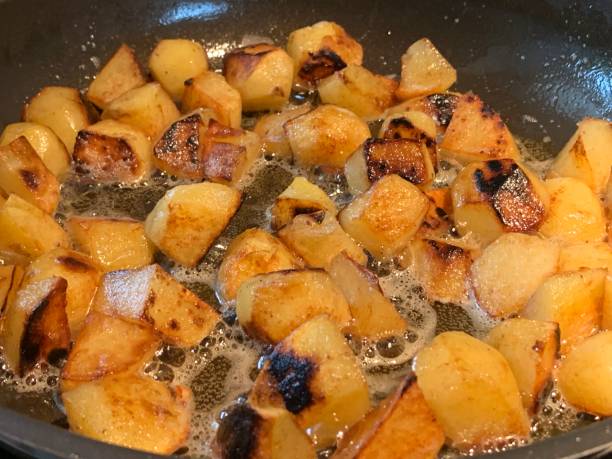 istock Roast potatoes fried with butter lard in an iron pan 1301889018