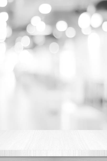 istock Vertical white table presentation, desk and blur background, Empty wood counter, shelf surface over blur restaurant white bokeh background, Wood table top for retail shop, store product display banner, mock up 1301889100