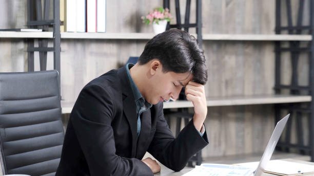 istock Asian businessman with frustrated and depressed expression while working office desk, office lifestyle 1301889788