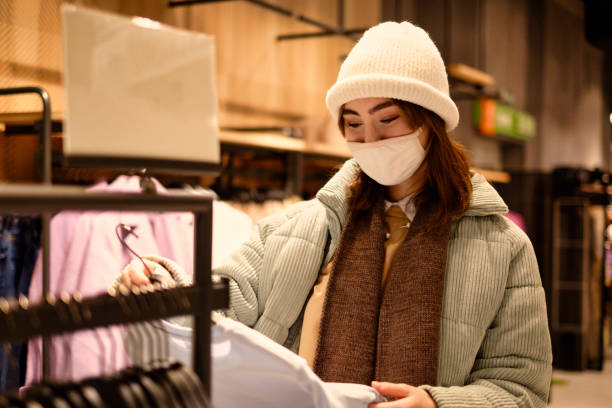 istock Women in a protective mask doiing shoppig 1301890572