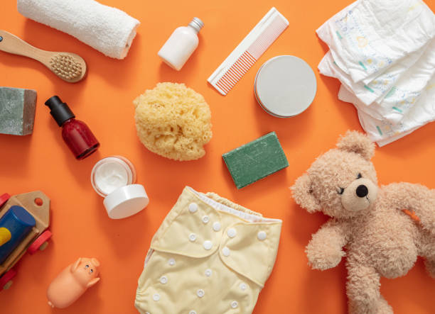 Baby bathing and diaper changing products background, top view Newborn bath and shower supplies on orange color background, top view. Baby body care natural and healthy products. Cloth diaper changing flat lay. sponge bath sponge nature animal stock pictures, royalty-free photos & images