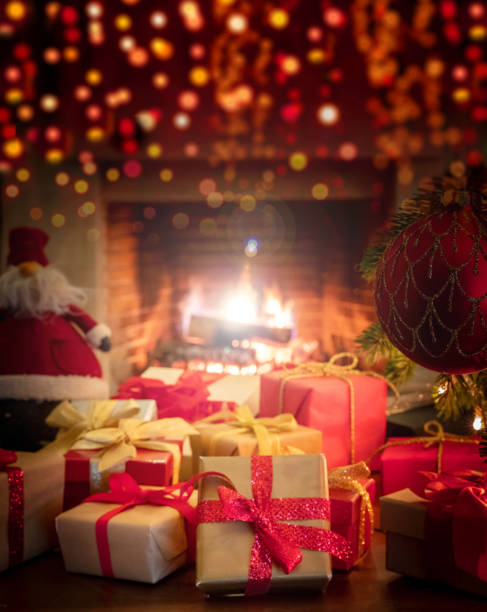 istock Xmas at home. Colorful gift boxes, bokeh blur burning fireplace background. 1301895605