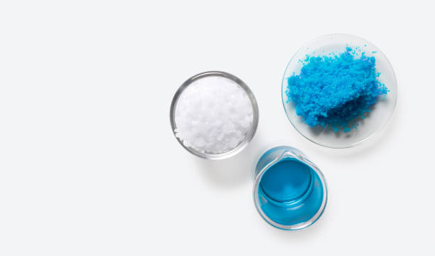 istock Inorganic chemical on white laboratory table. Copper(II) sulfate, Microcrystalline wax, alcohol. Chemical ingredient for Cosmetics and Toiletries product. Top View 1301898172
