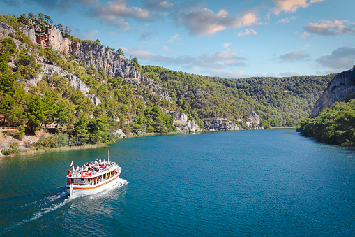 Ship with tourists at Krka national park ( Nacionalni park Krka ) going to Skradinski Buk waterfalls