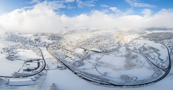 Image of aerial photography with drone of town Grafenau in Bavarian forest with mountains Arber Rachel and Lusen in winter with snow and ice, Germany