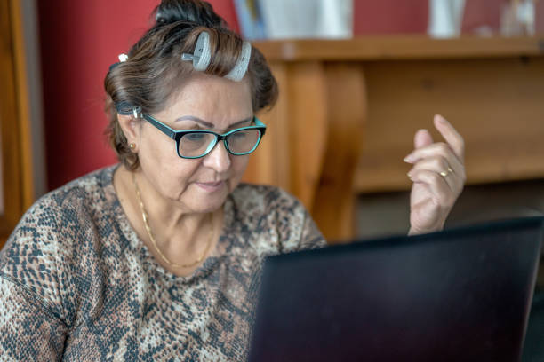 istock Mature Hispanic woman wearing hair rollers 1301903757