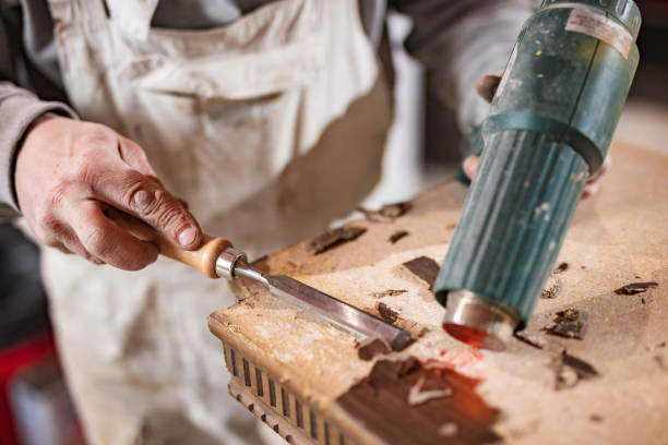 istock Male carpenter working on old wood in a retro vintage workshop. 1301905303