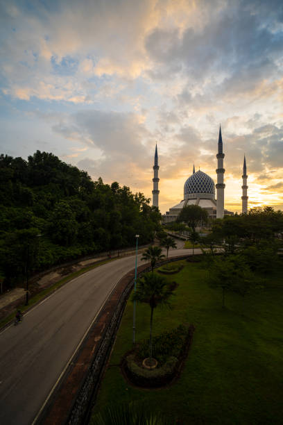 istock Shah alam mosque during sunrise with lonely road line 1301906451