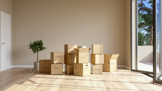 Moving In Or Moving Out A House. Books, Toys, Kitchen Utensils And Other Equipments Are In Cardboard Boxes In Empty Room.