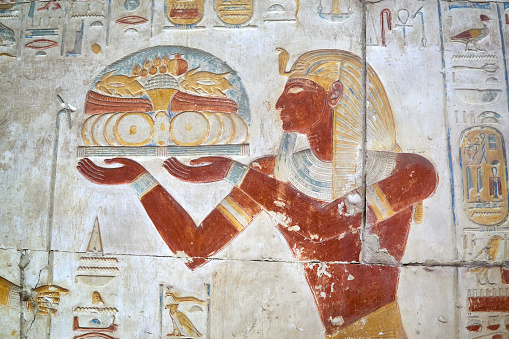A colourful wall painting with Ancient Egyptian Pharaoh presenting offerings to the gods, Abydos, Egypt