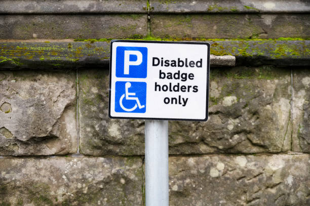 istock Disabled blue badge holder parking sign for driver 1301911356