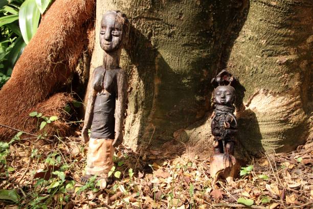 Two Voodoo fetishes at a ritual place close Avepozo, Togo, West Africa Avepozo, Togo - February 20, 2019: Voodoo cult close the village Avepozo, Togo, West Africa. People celebrate their beliefs and rituals with two fetishes. Voodoo is a strong religion in West Africa with a lot of power in society. ceremonial dancing stock pictures, royalty-free photos & images