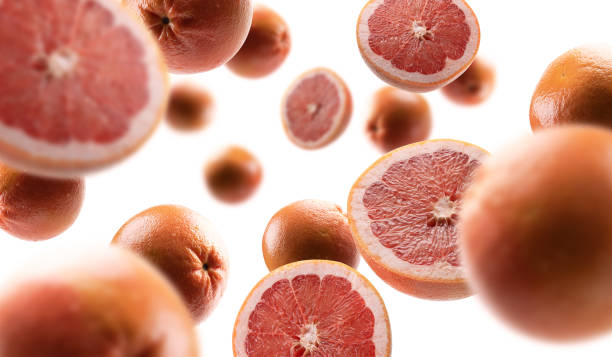 istock Whole and cut grapefruits levitate on a white background 1301911804