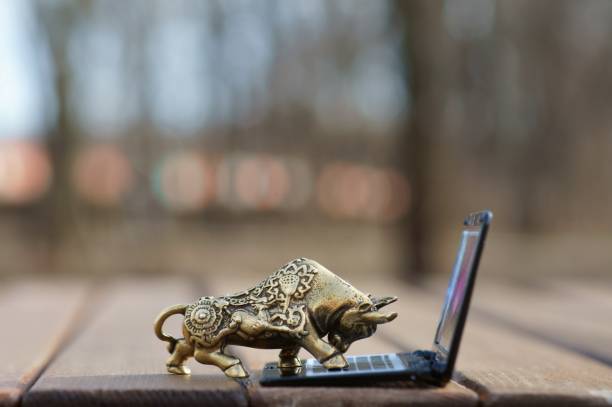 istock Metal bull with a laptop close-up. 1301912510
