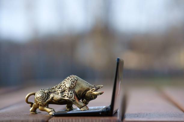 istock Metal bull with a laptop close-up. 1301912513