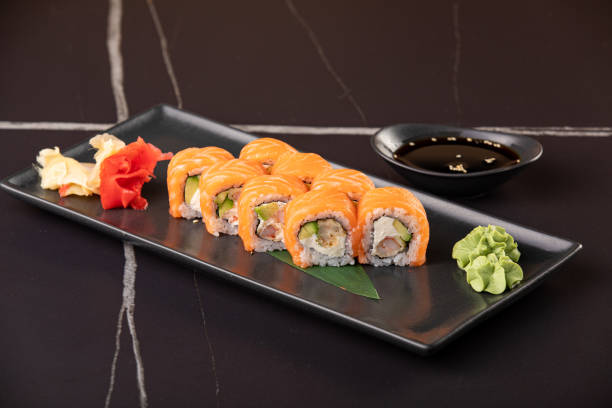 istock Sushi roll with salmon and shrimp tempura on black background 1301913614