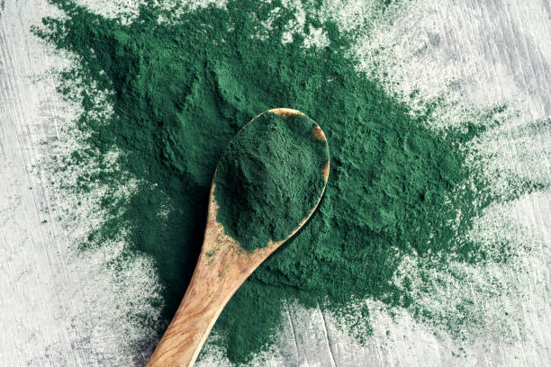 istock Spirulina powder on a spoon on a table 1301913989