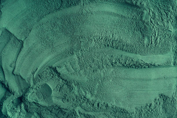 istock Green background made of spirulina algae powder 1301914020