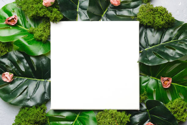istock Mockup poster frame and green tropical leaves. 1301914605