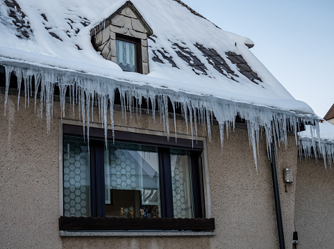 Icicles hang from roof in winter