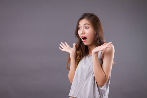 istock excited woman looking up studio isolated portrait 1301919849